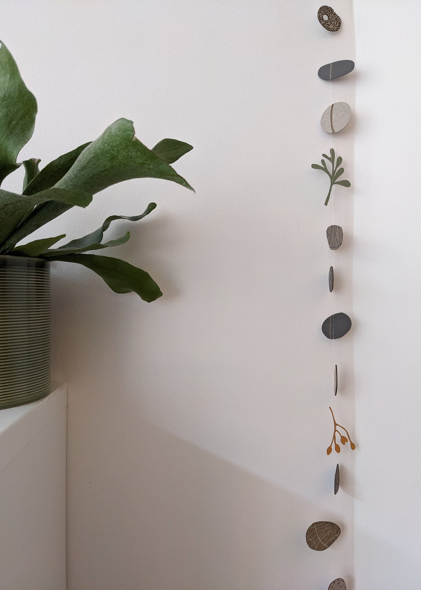 a large collection of paper pebbles & seaweed