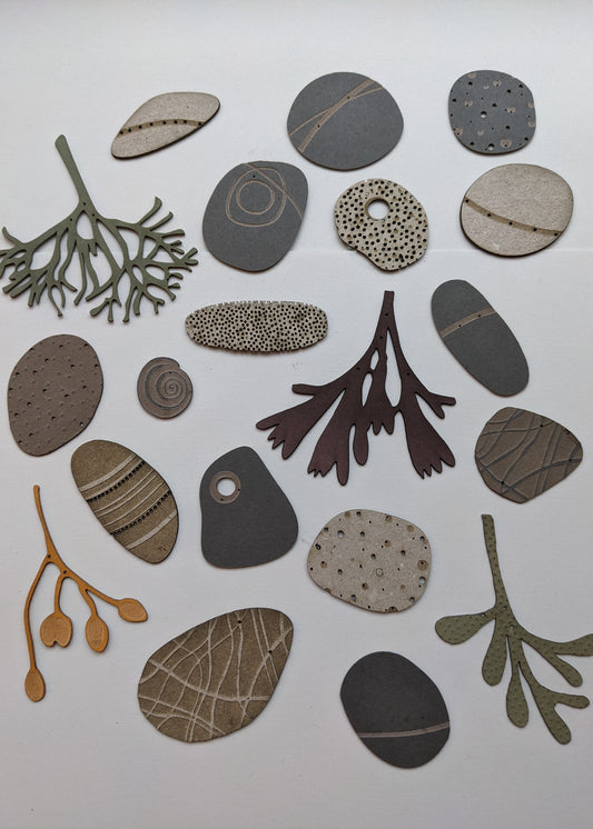 a large collection of paper pebbles & seaweed